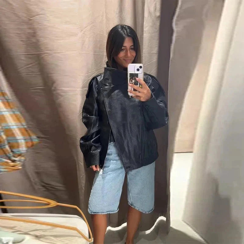 Chic short leather jacket with polished finish, stand collar, and zipper closure in a relaxed fit.