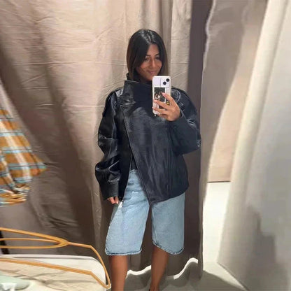 Chic short leather jacket with polished finish, stand collar, and zipper closure in a relaxed fit.