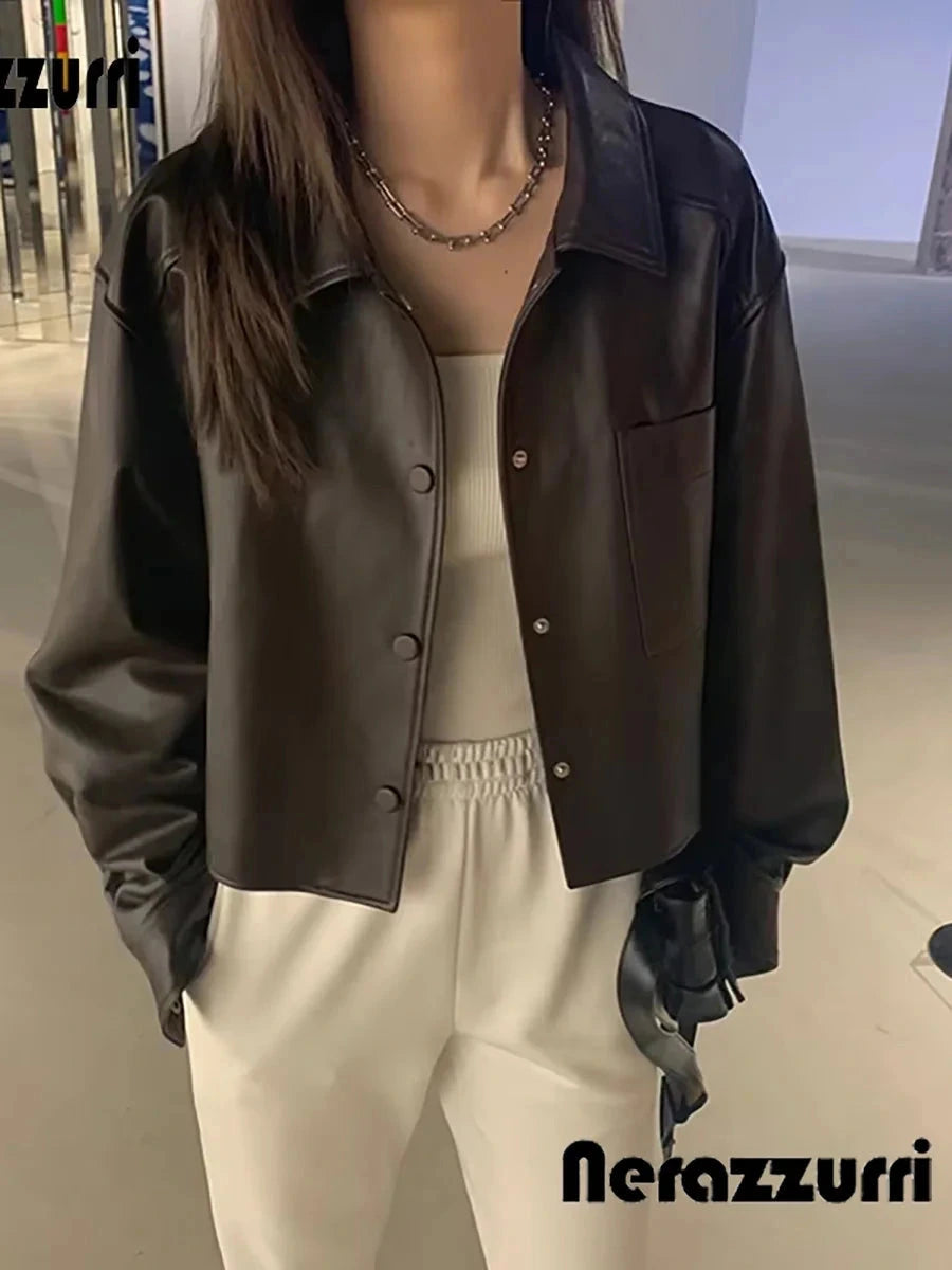 Chic short faux leather jacket with a loose fit, single-breasted design, and functional pockets.