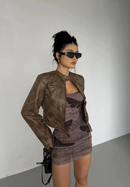 Black stand collar leather jacket with zip closure and side pockets, displayed on a mannequin against a neutral background.