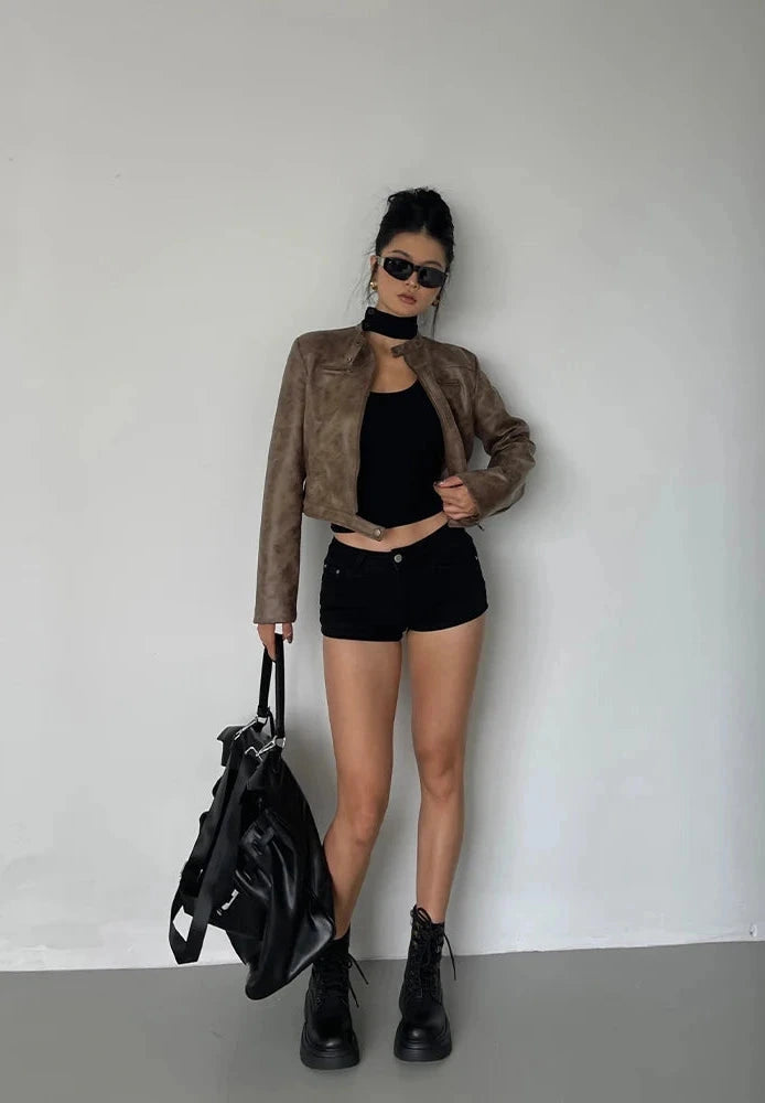 Black stand collar leather jacket with zipper closure and side pockets.