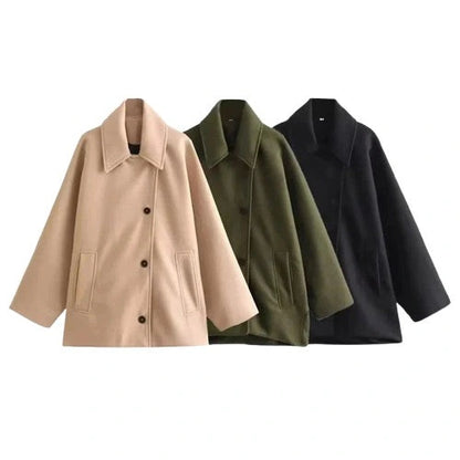 Chic oversized long jacket with a loose fit, single-breasted design, and practical pockets for layering.