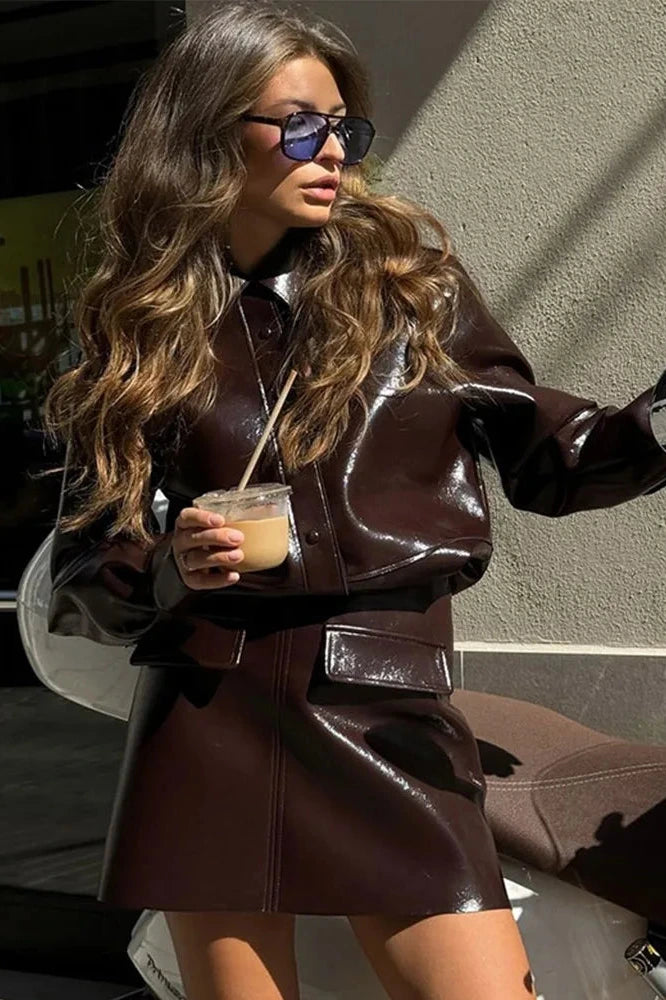 Refined leather jacket and mini skirt ensemble with single-breasted closure and turn-down collar, made from polyester.