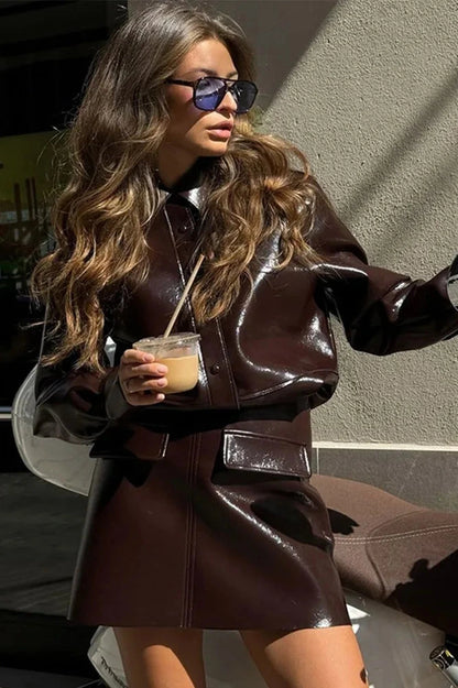 Refined leather jacket and mini skirt ensemble with single-breasted closure and turn-down collar, made from polyester.