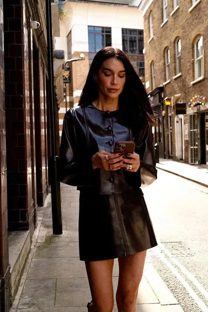 Refined leather jacket and mini skirt ensemble with single-breasted closure and turn-down collar, made from polyester.