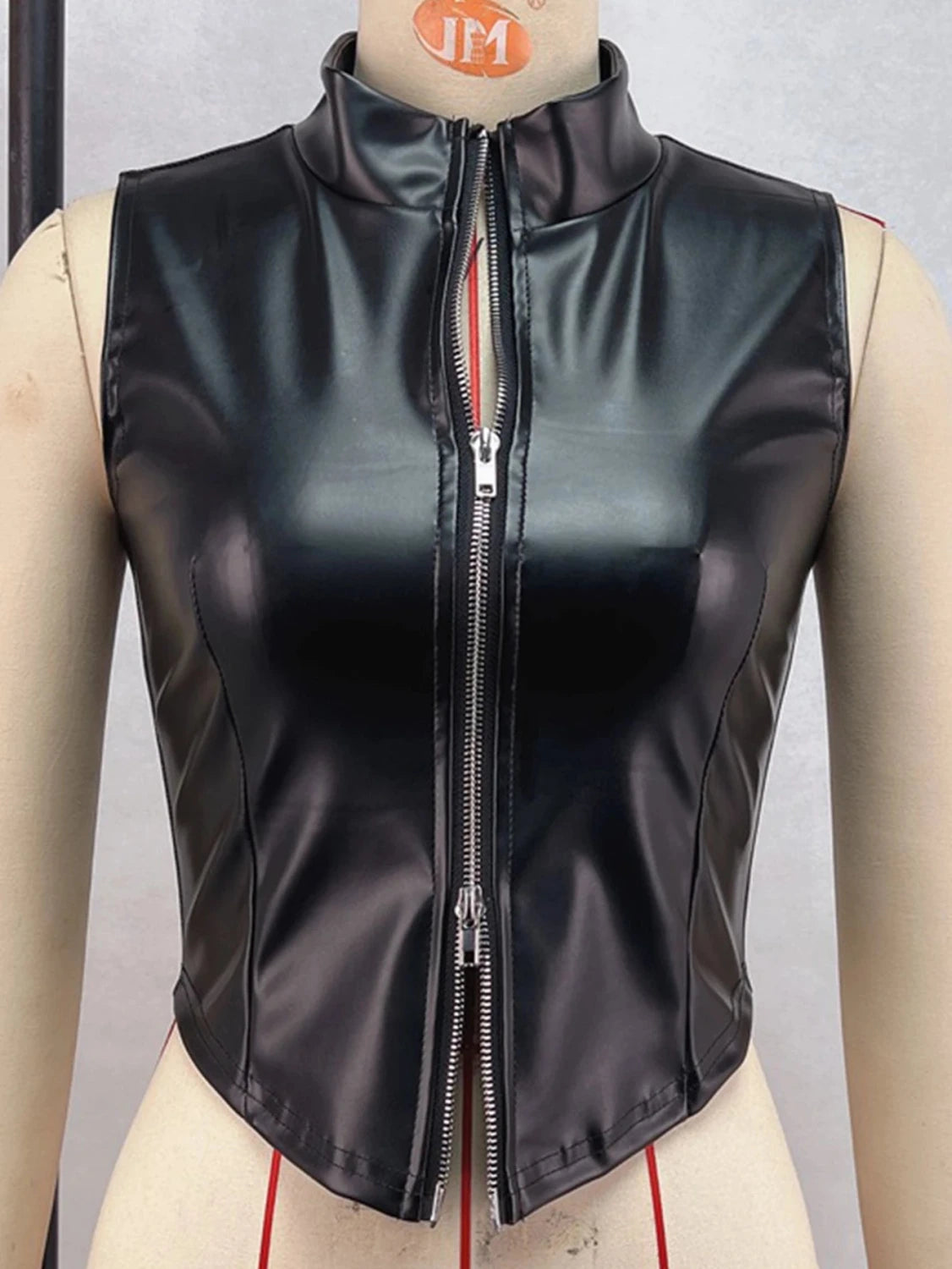 Chic black zippered crop top in PU leather with medium stretch and regular length, perfect for casual and clubwear styles.