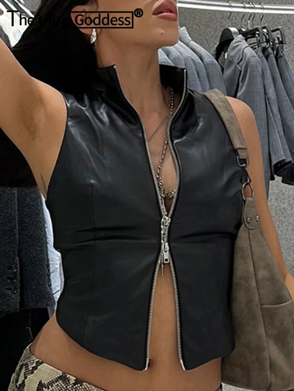 Chic black zippered crop top in PU leather with medium stretch and regular length, perfect for casual and clubwear styles.