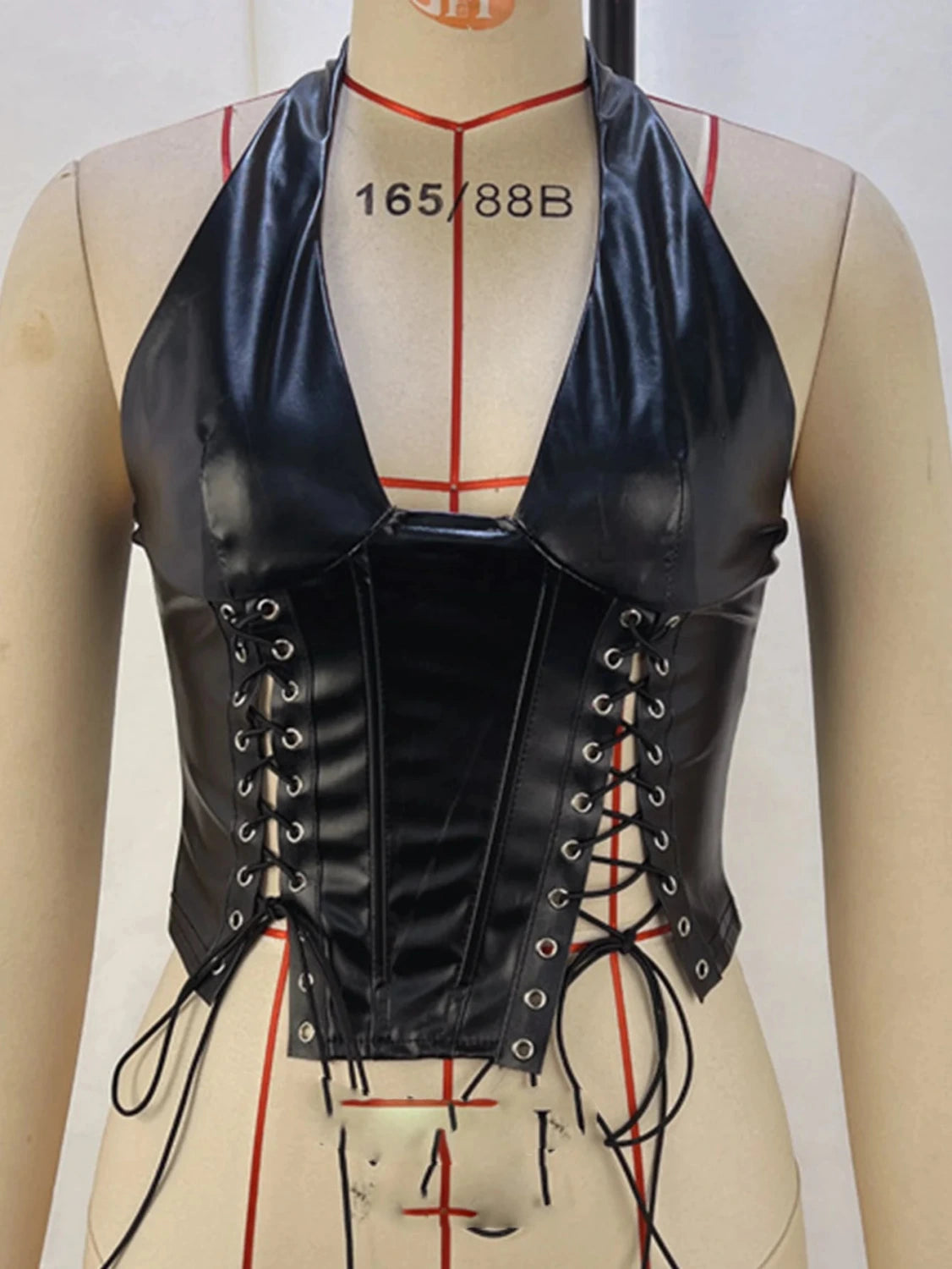 Halter neck PU leather corset crop top with lace-up back and cropped length, ideal for nightlife and music festivals.