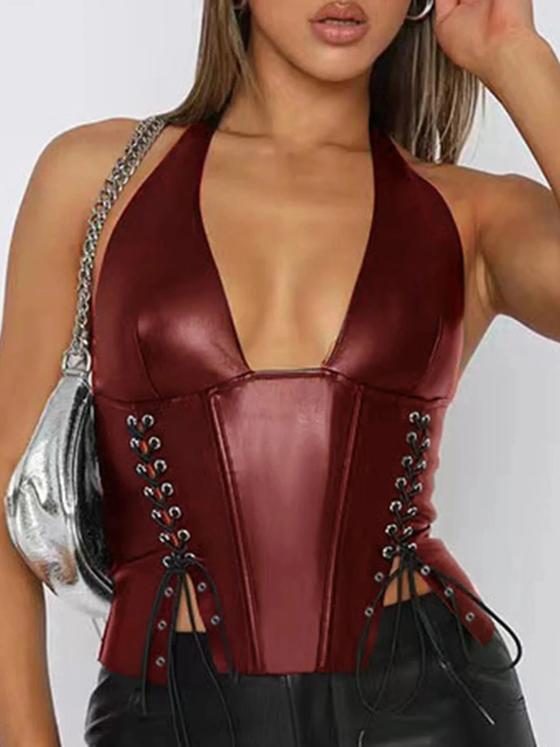 Halter neck PU leather corset crop top with lace-up back and cropped length, ideal for nightlife and festivals.