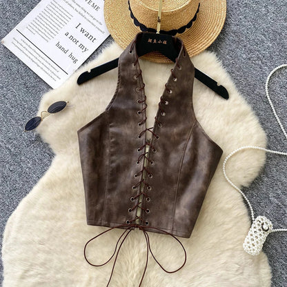 Chic black PU leather crop top with rope straps and hollow-out design, featuring a fitted silhouette and super-short length.