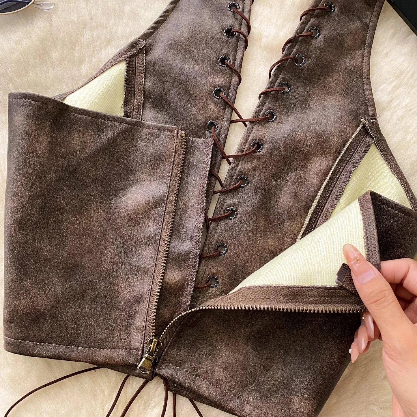 Chic black PU leather crop top with rope straps and hollow-out design, featuring a fitted silhouette and super-short length.