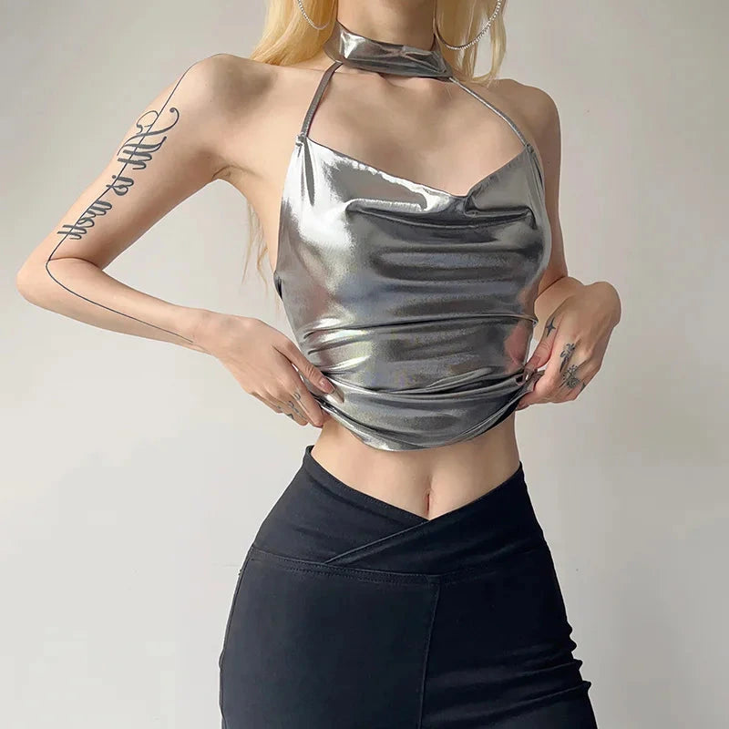Shiny silver patent leather halter crop top with a backless design and slim fit, perfect for evening wear.