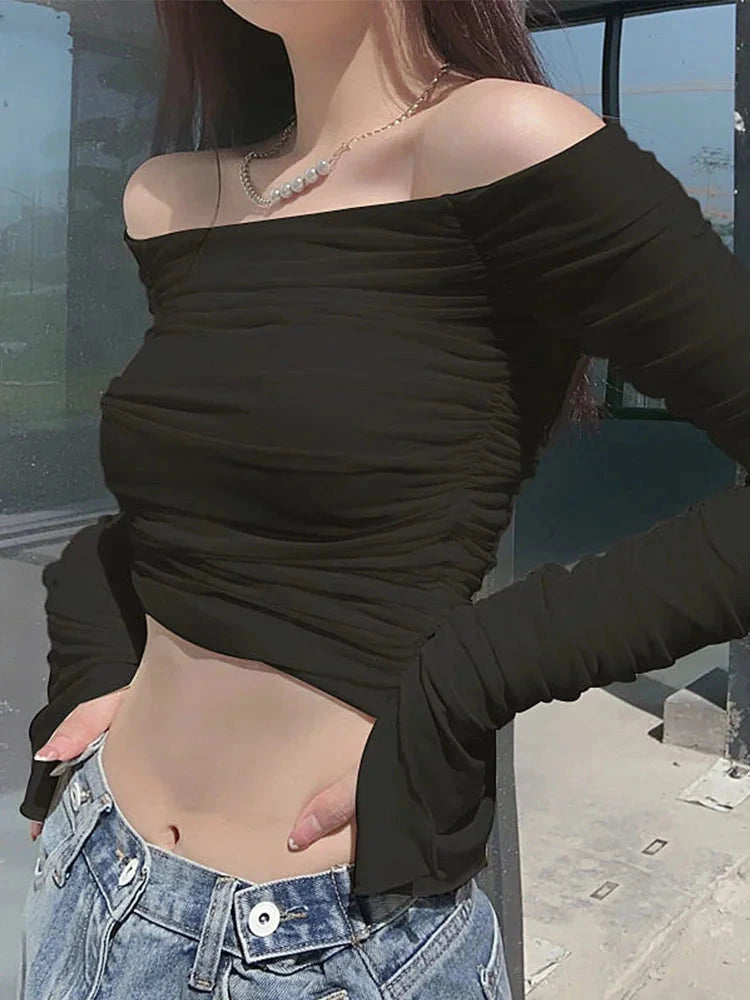 Elegant off-shoulder ruched crop top with mesh detail and full sleeves in a cotton and polyester blend.