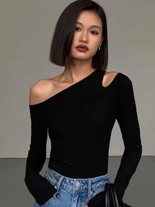 Refined off-shoulder long-sleeved crop top in classic black with a skew collar and flare sleeves.