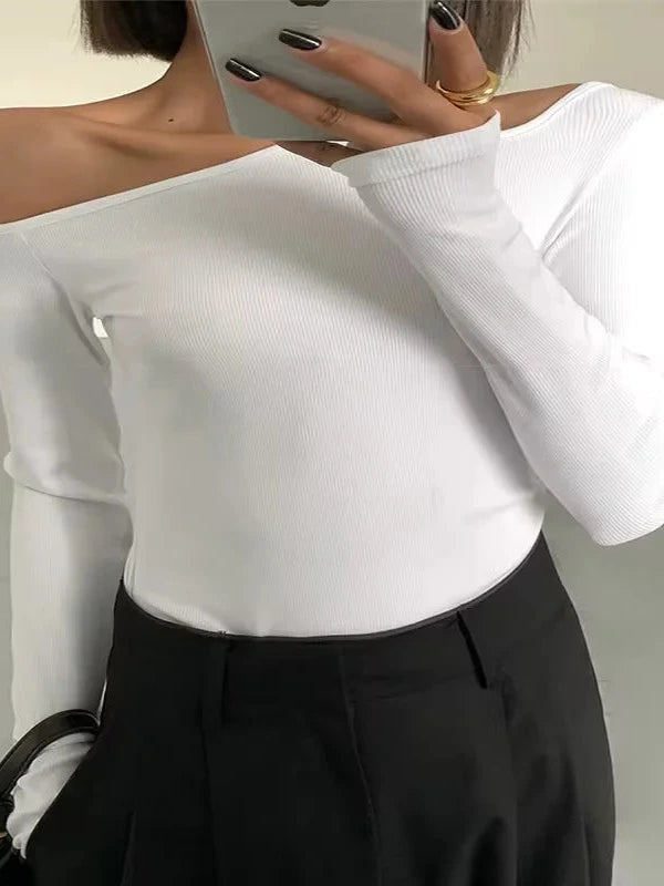 Refined off-shoulder long-sleeved crop top in bright white with skew collar and flare sleeves.