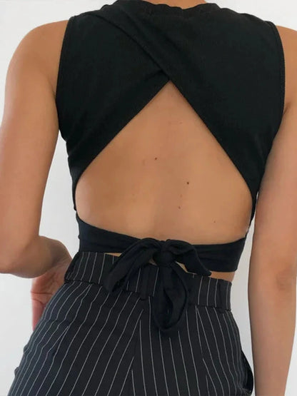 Chic backless criss-cross tank top in soft cotton blend with slim fit and short length, ideal for casual summer wear.