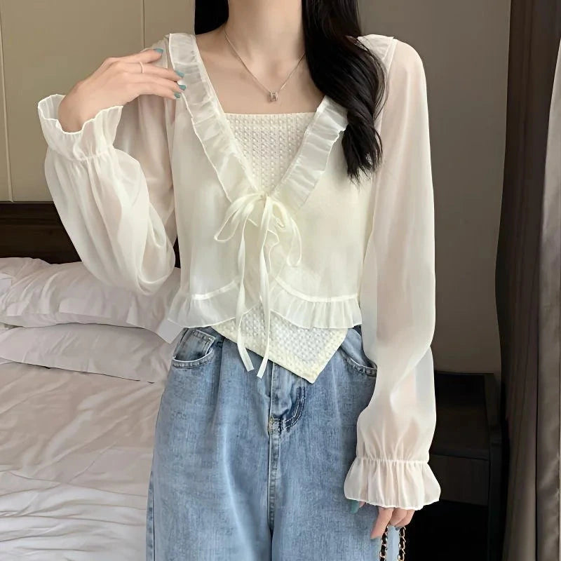 Chic ruffled chiffon cape with long sleeves, featuring an open stitch design and lightweight polyester blend fabric.