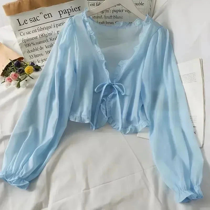 Sky blue ruffled chiffon cape with long sleeves and open stitch design, perfect for layering over dresses or tops.
