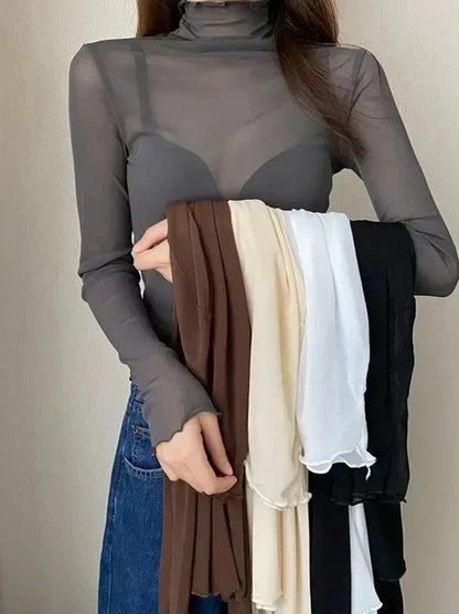 Sheer long sleeve turtleneck lace crop top in lightweight fabric with a slim fit and pullover style.