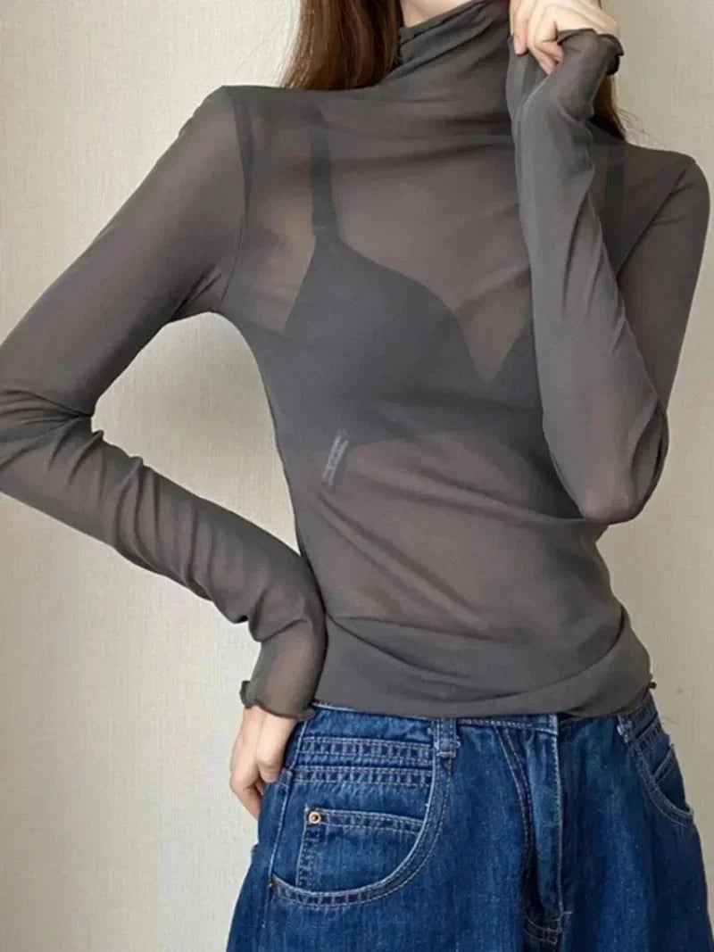 Sheer long sleeve turtleneck lace crop top in lightweight fabric with a slim fit and pullover style.