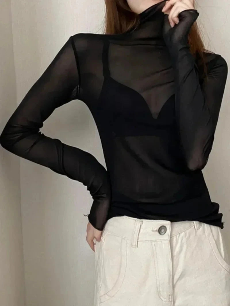 Sheer long sleeve turtleneck lace crop top in slim fit, made from lightweight lace for layering or standalone wear.
