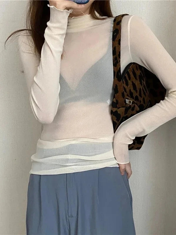 Sheer long sleeve turtleneck lace crop top in lightweight fabric with a slim fit and pullover style.