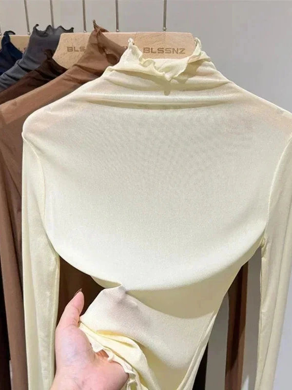 Sheer long sleeve turtleneck lace crop top in lightweight fabric with a slim fit and pullover style.