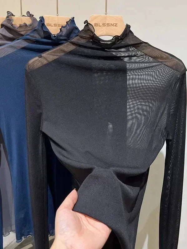 Sheer long sleeve turtleneck lace crop top in deep black with a slim fit and lightweight design.