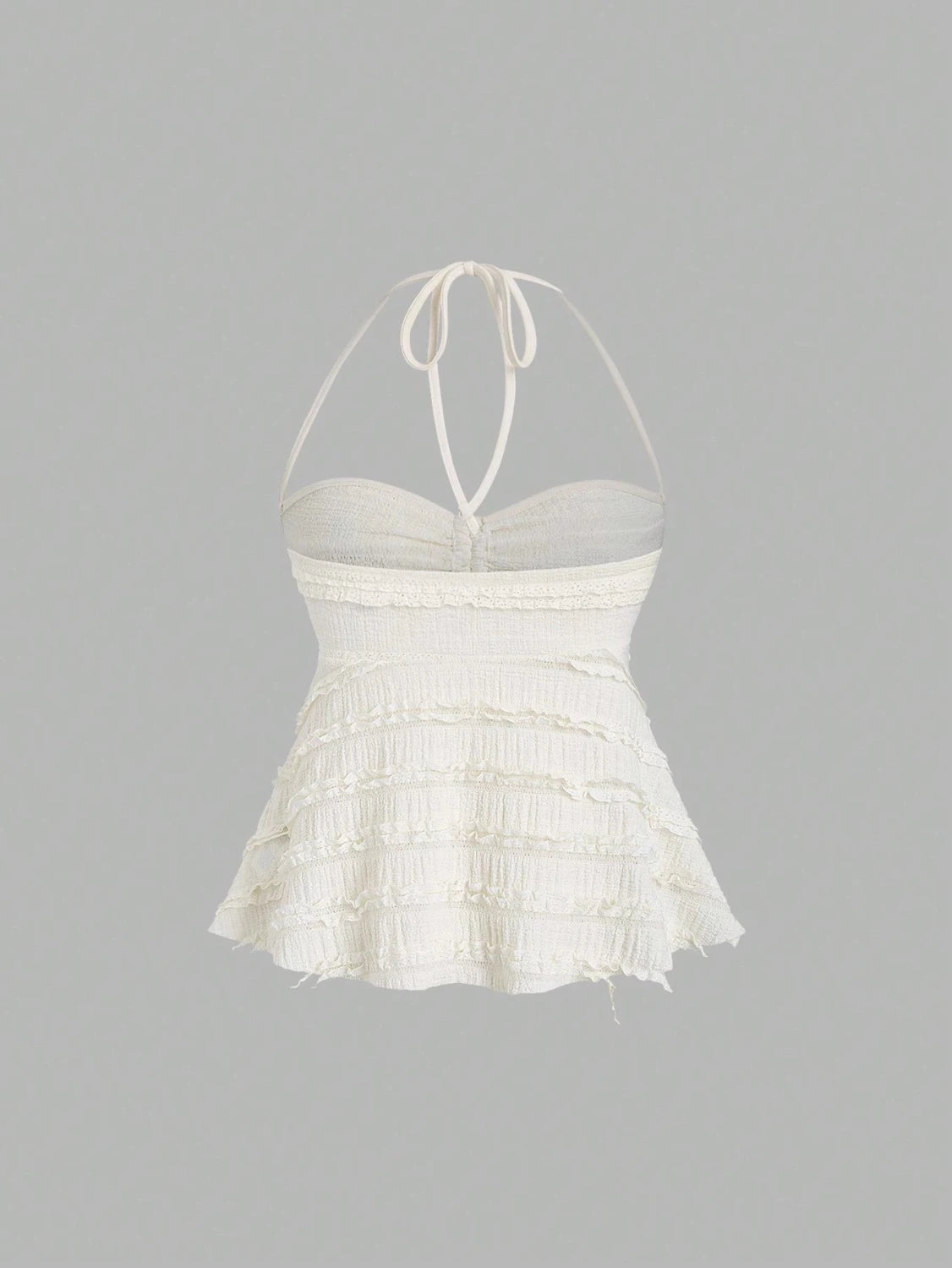 Textured halter neck knitted vest top with drawstring detail and backless design in a soft apricot hue.