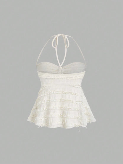 Textured halter neck knitted vest top with drawstring detail and backless design in a soft apricot hue.