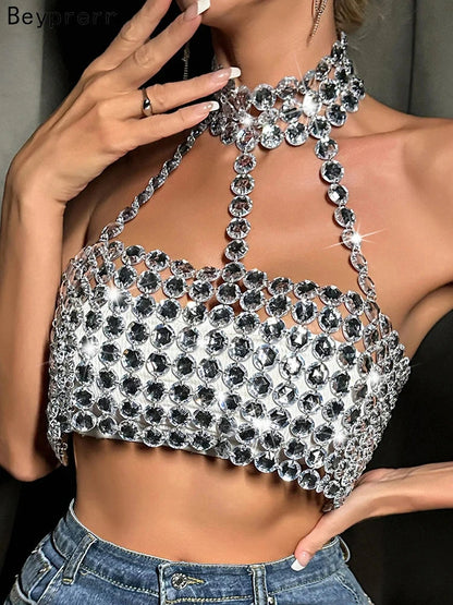 Silver halter tank top with glittering sequin detail and backless design, perfect for clubwear and festive occasions.