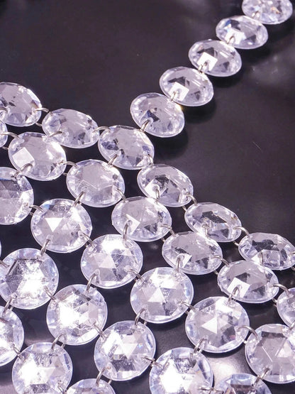 Silver halter tank top with glittering sequin detail and backless design, perfect for clubwear and festive occasions.