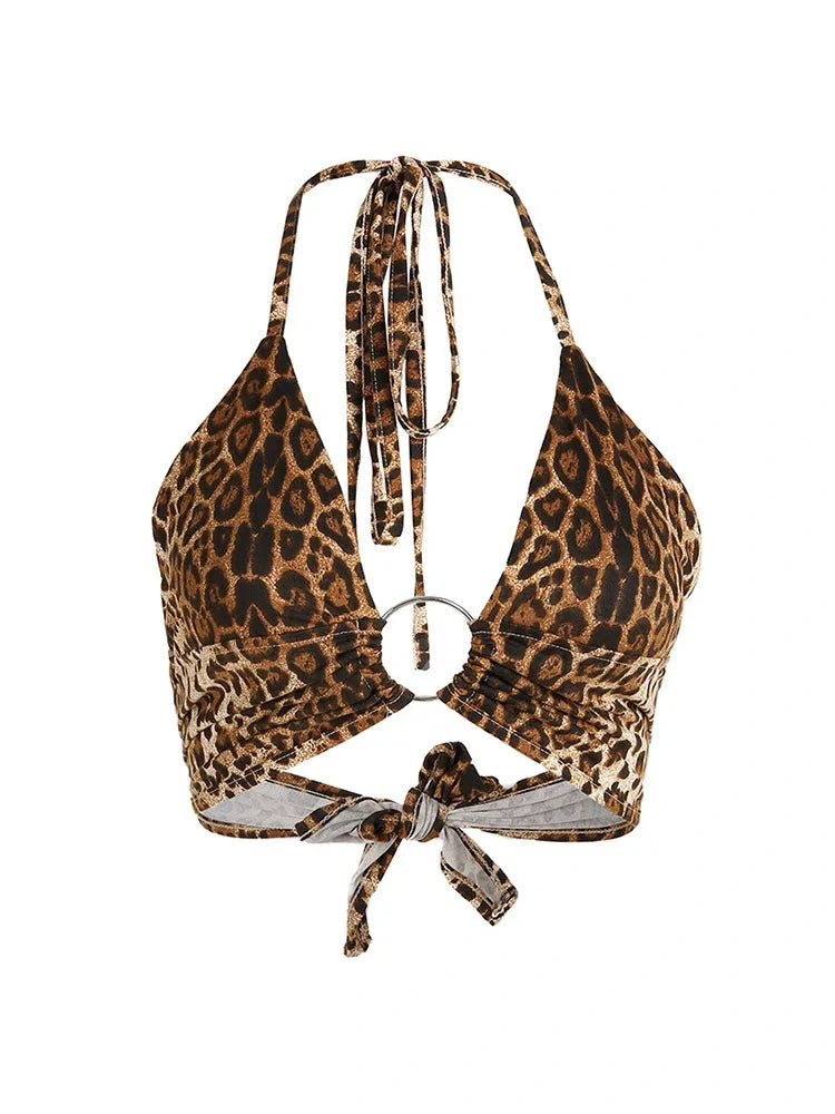Leopard print halter crop top with backless design and metallic ring detail, made from lightweight polyester fabric.