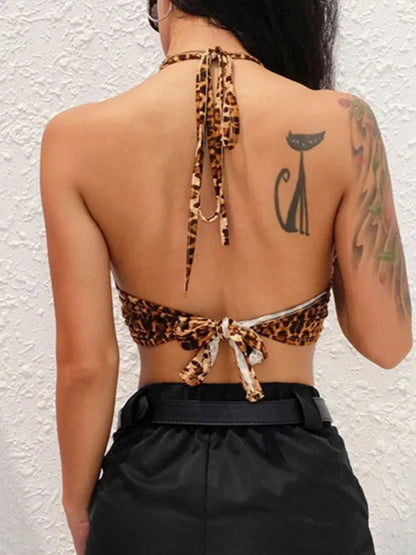 Leopard print halter crop top with backless design and metallic ring detail, made from lightweight polyester fabric.