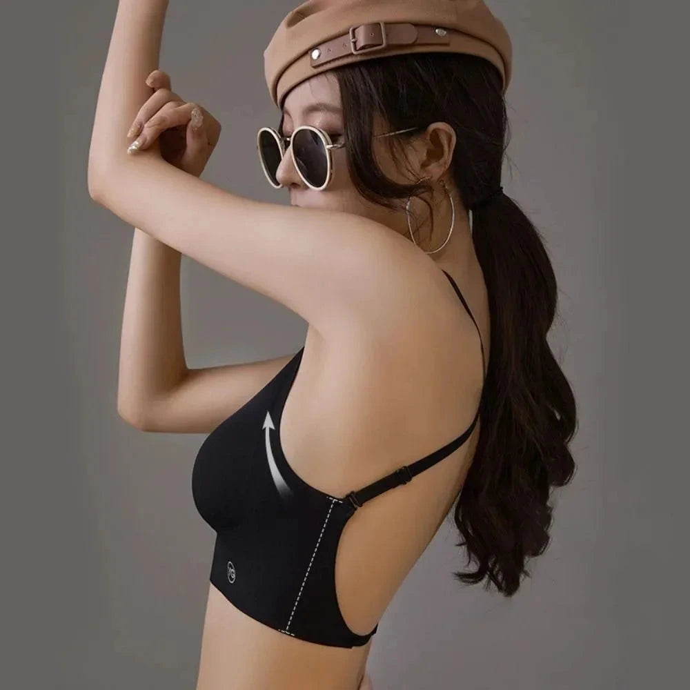 Backless triangle cup bra with U-shaped back design and adjustable straps, made from nylon and acrylic blend.