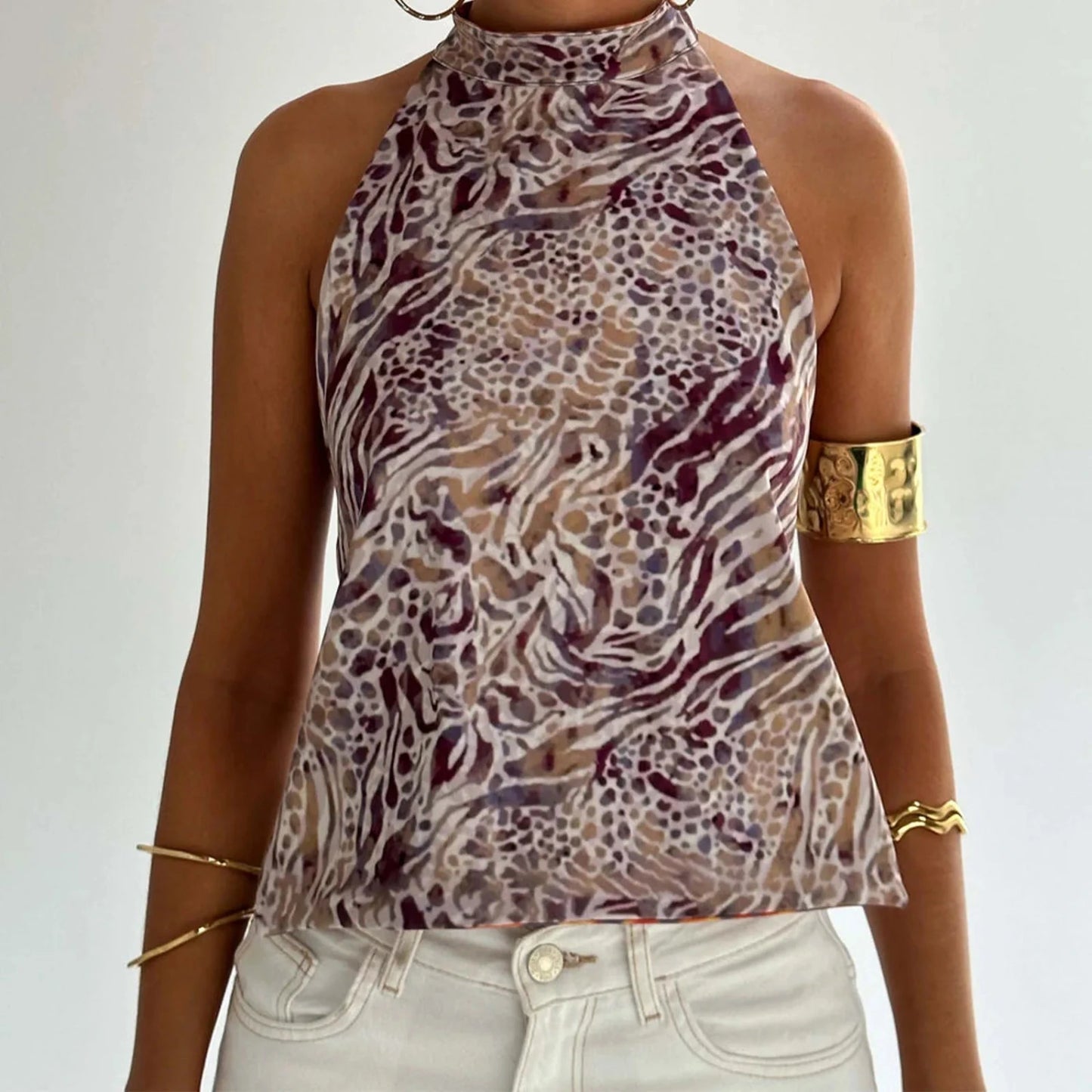 Elegant sleeveless halter top with polka dot print in a cotton polyester blend, designed for casual and party wear.