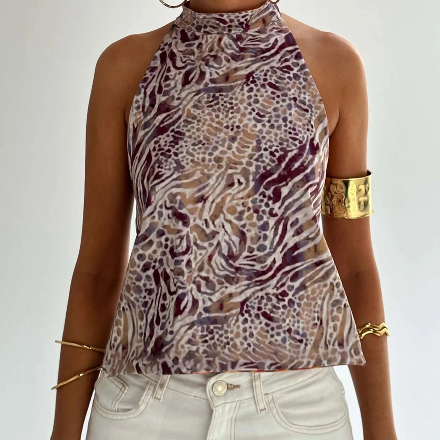 Elegant sleeveless halter top with polka dot print in a cotton polyester blend, designed for casual and party wear.