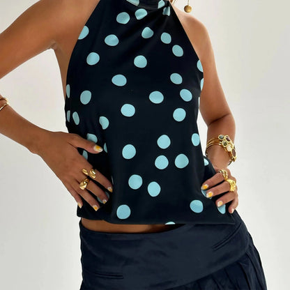 Elegant sleeveless halter top with polka dot print in a cotton polyester blend, designed for casual and party wear.
