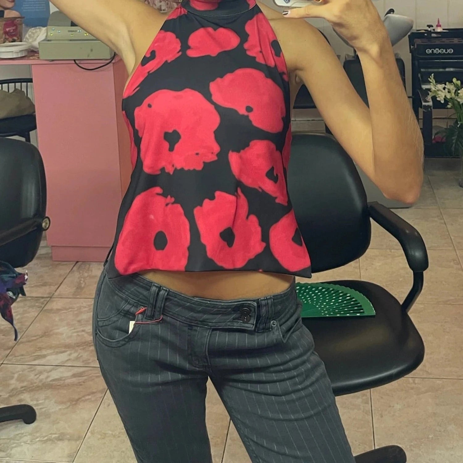 Elegant sleeveless halter top with polka dot print, made from a cotton polyester blend, ideal for casual outings.