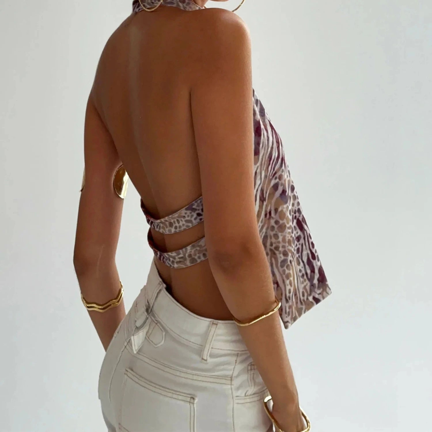 Elegant sleeveless halter top with polka dot print in a cotton polyester blend, designed for casual and party wear.