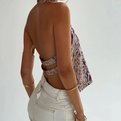 Elegant sleeveless halter top with polka dot print in a cotton polyester blend, designed for casual and party wear.