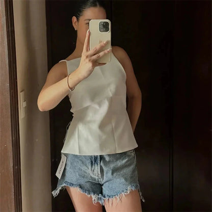 Elegant backless crop top in classic black with delicate straps and lightweight polyester fabric. Ideal for evening wear.