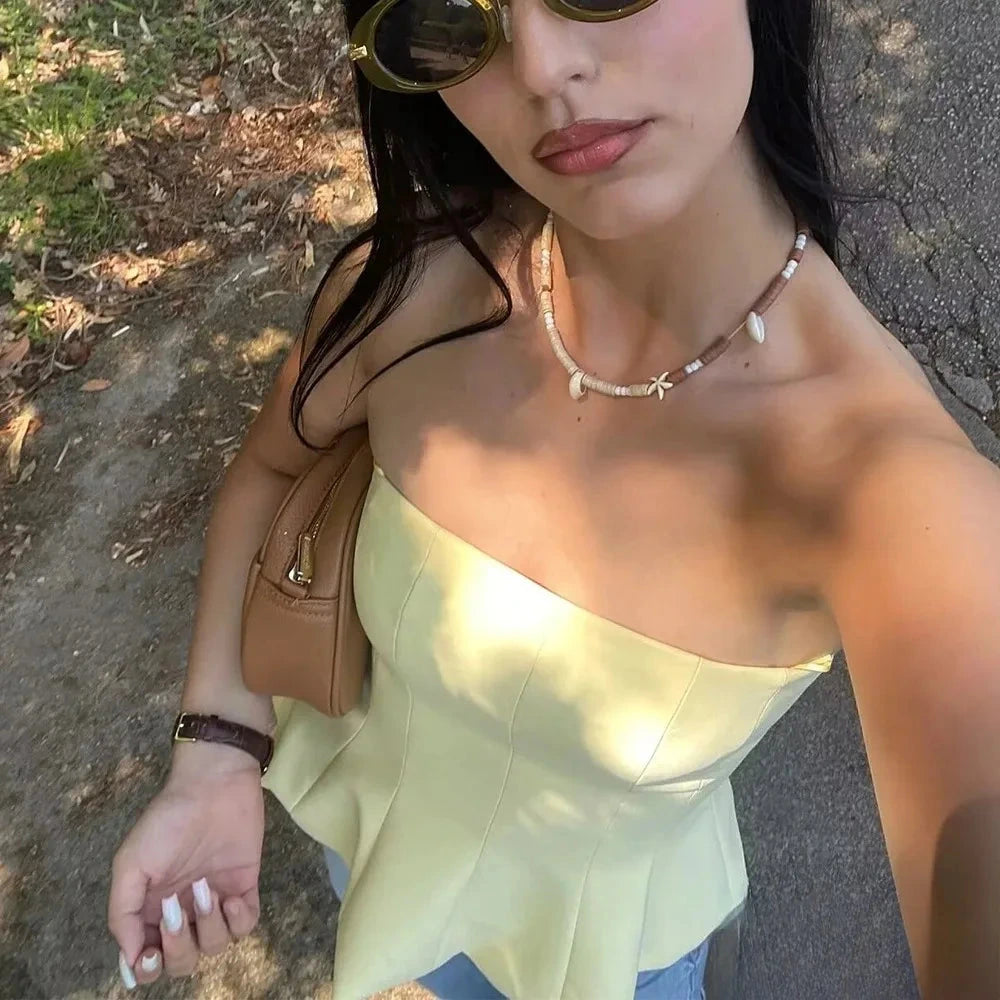 Butter yellow ruffled cami top with a strapless silhouette and lightweight polyester material.