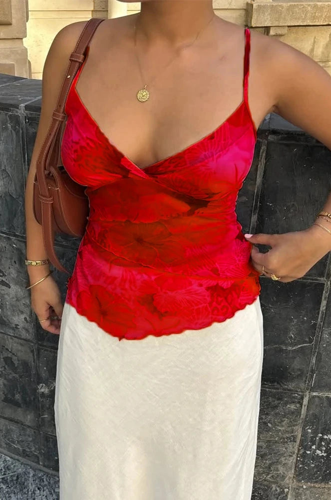 Floral print boho spaghetti strap crop top with lightweight mesh overlay and slight stretch. Ideal for summer events.