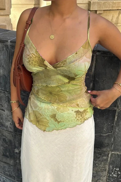 Floral print boho spaghetti strap crop top with lightweight mesh overlay and slight stretch. Ideal for summer events.