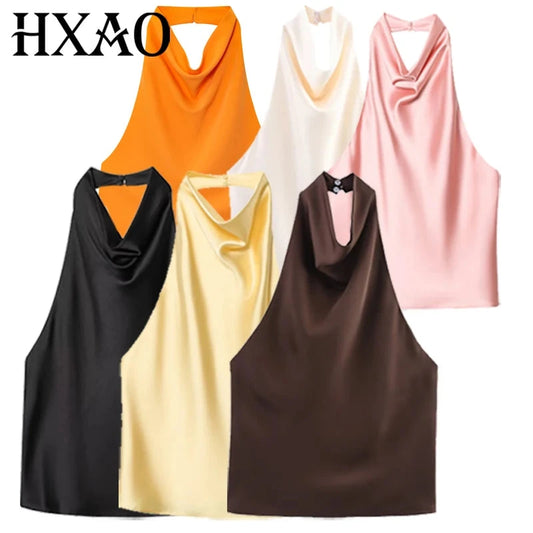 Satin halter top with backless design, sleeveless silhouette, and short length, suitable for beachwear and casual outings.