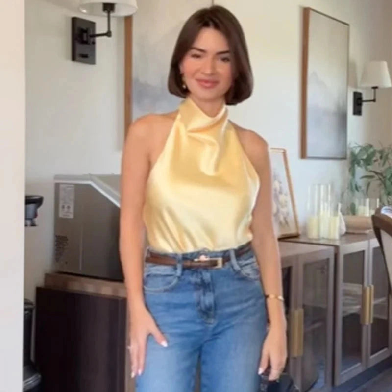 Satin halter top with backless design, sleeveless silhouette, and short length, perfect for beachwear or casual outings.