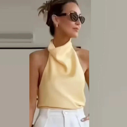 Satin halter top with backless design, sleeveless silhouette, and short length, suitable for beachwear and casual outings.