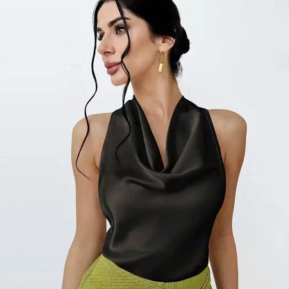 Satin halter top with backless design, sleeveless silhouette, and short length, suitable for beachwear and casual outings.