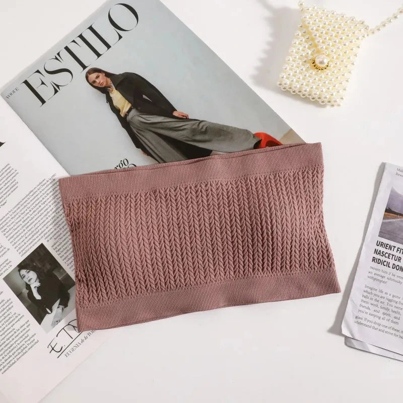 Dusty rose seamless ribbed bandeau top with a flexible fit and strapless design, made from a nylon and spandex blend.